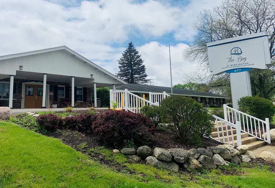 Exterior view of a senior living facility with signage