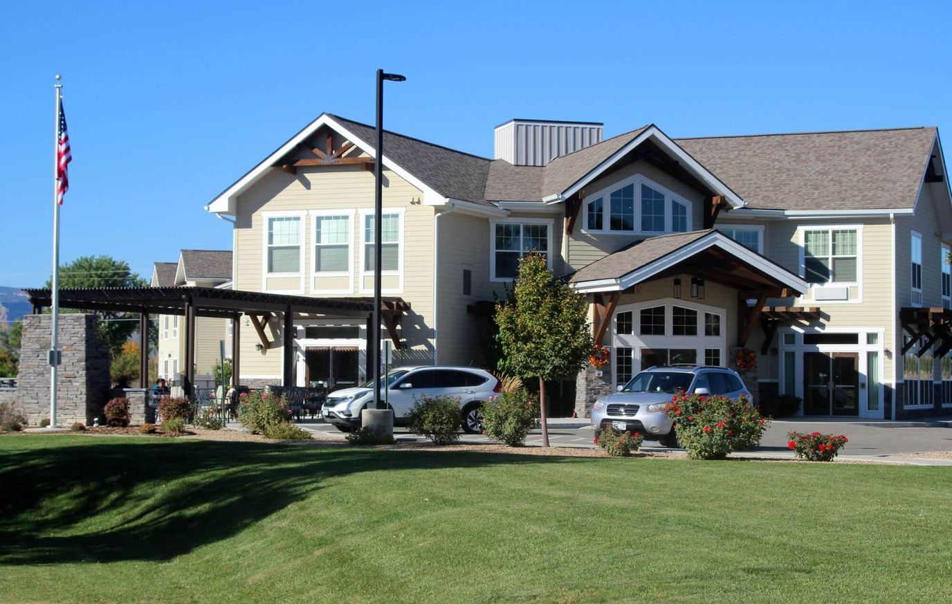 Front exterior view of a senior living facility with landscaping