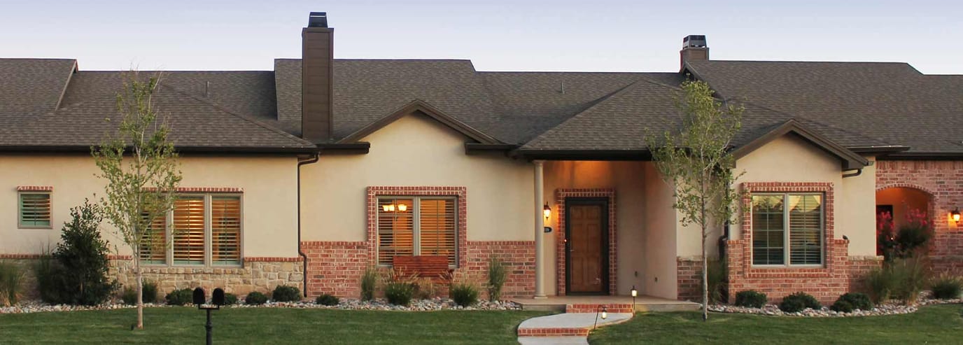Exterior view of a senior living facility with landscaped entrance