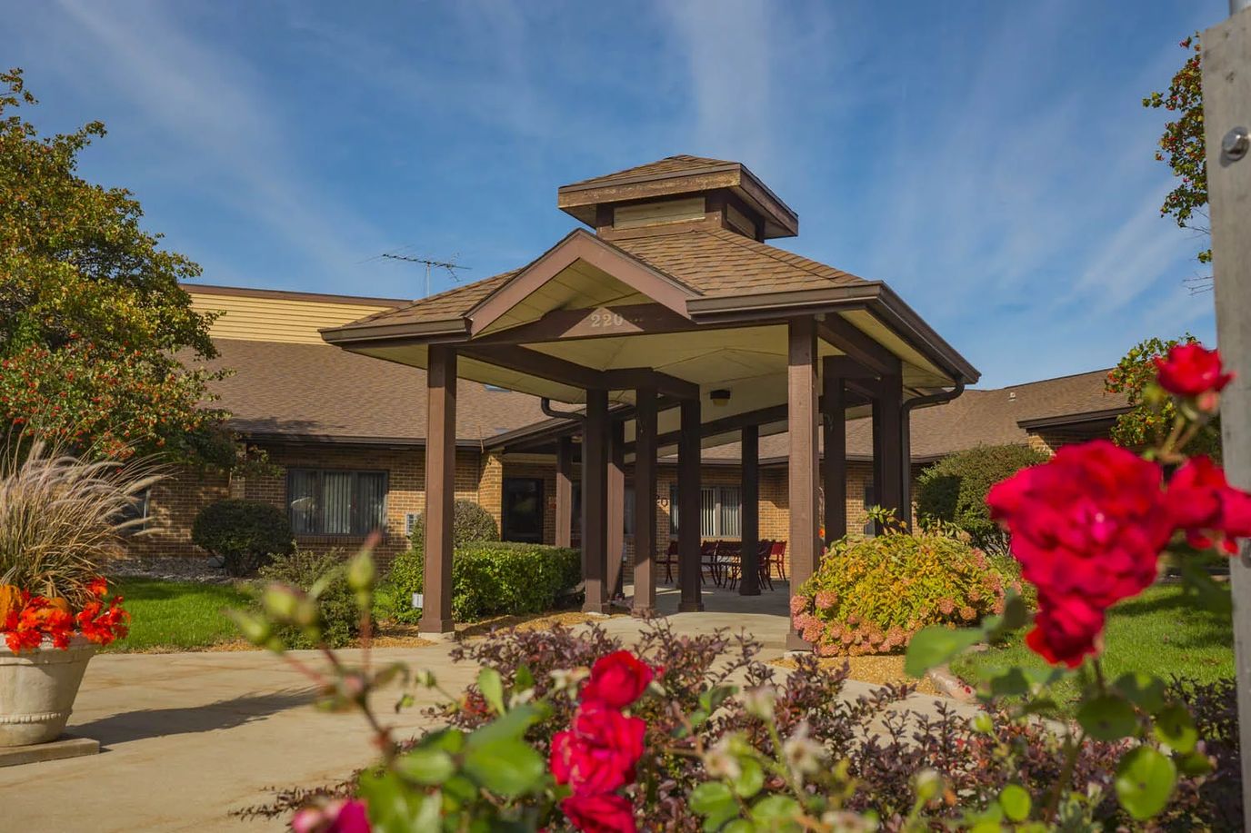 Entrance of Carmel Residence surrounded by flowers