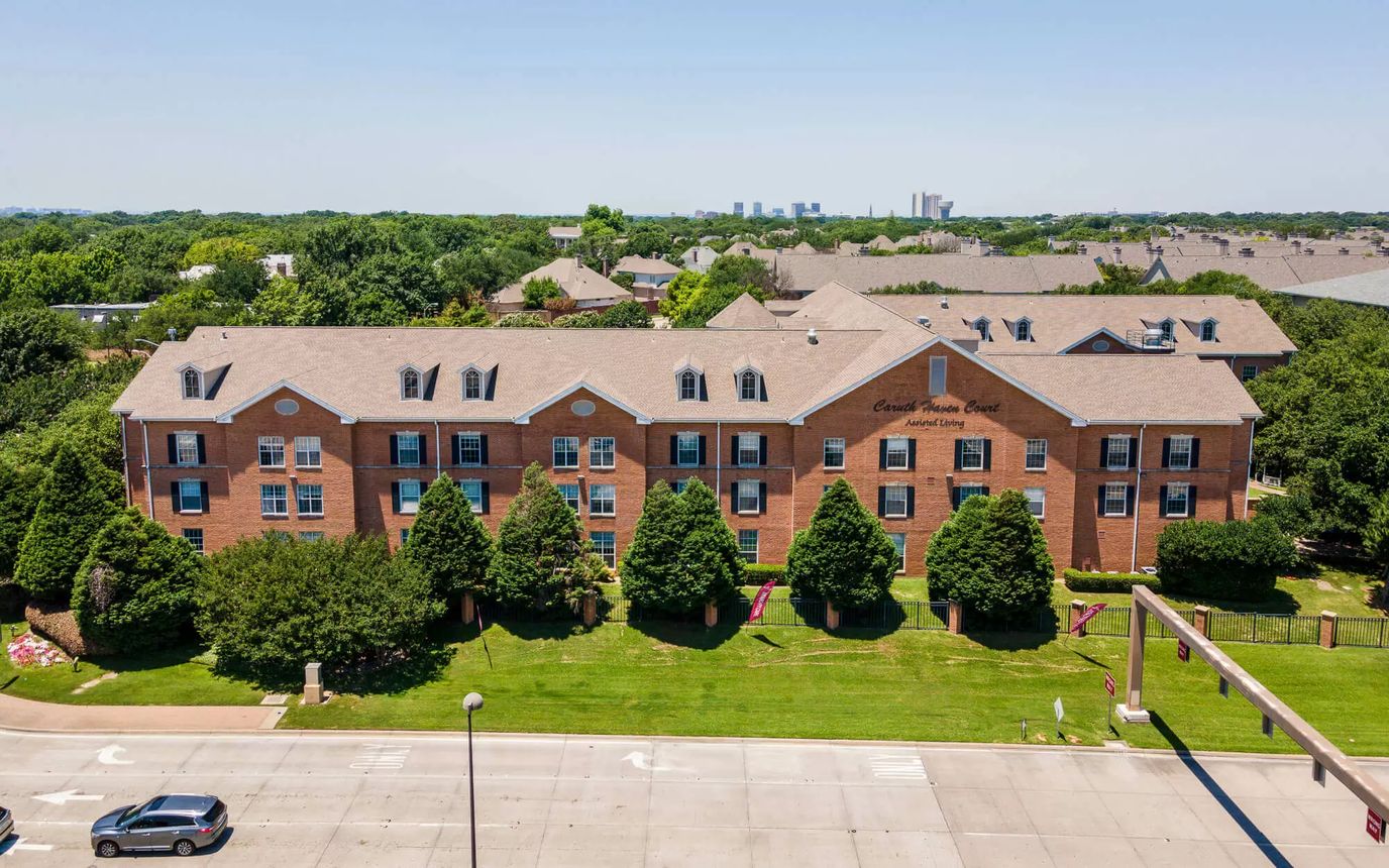 Exterior view of a senior living facility with landscaping