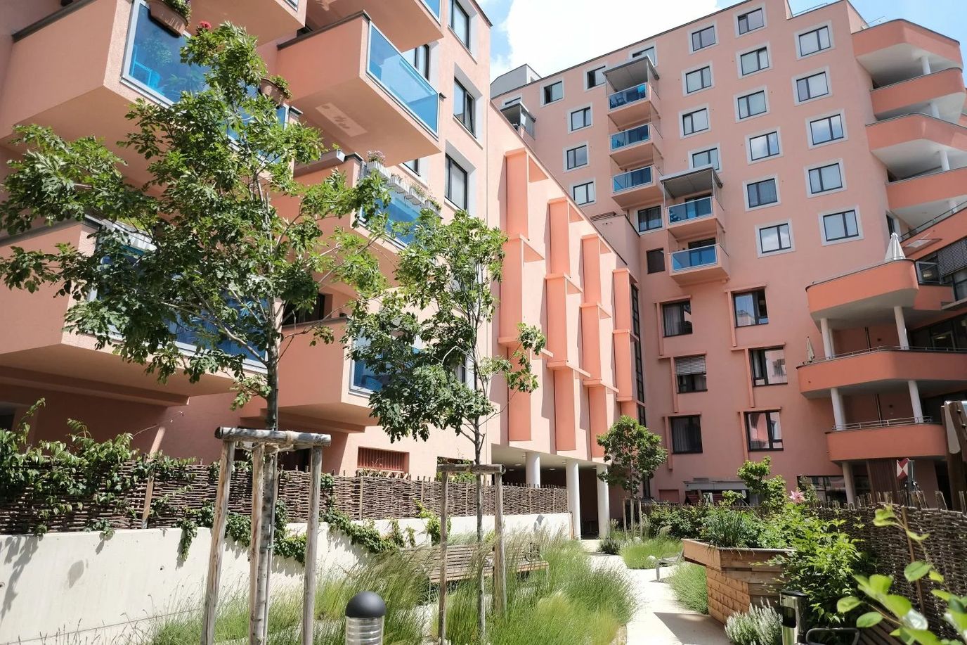 Outdoor space with plants and building balconies