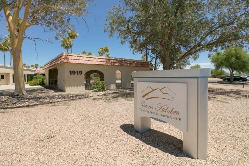 Exterior view of Casas Adobes Post Acute Rehabilitation Center sign