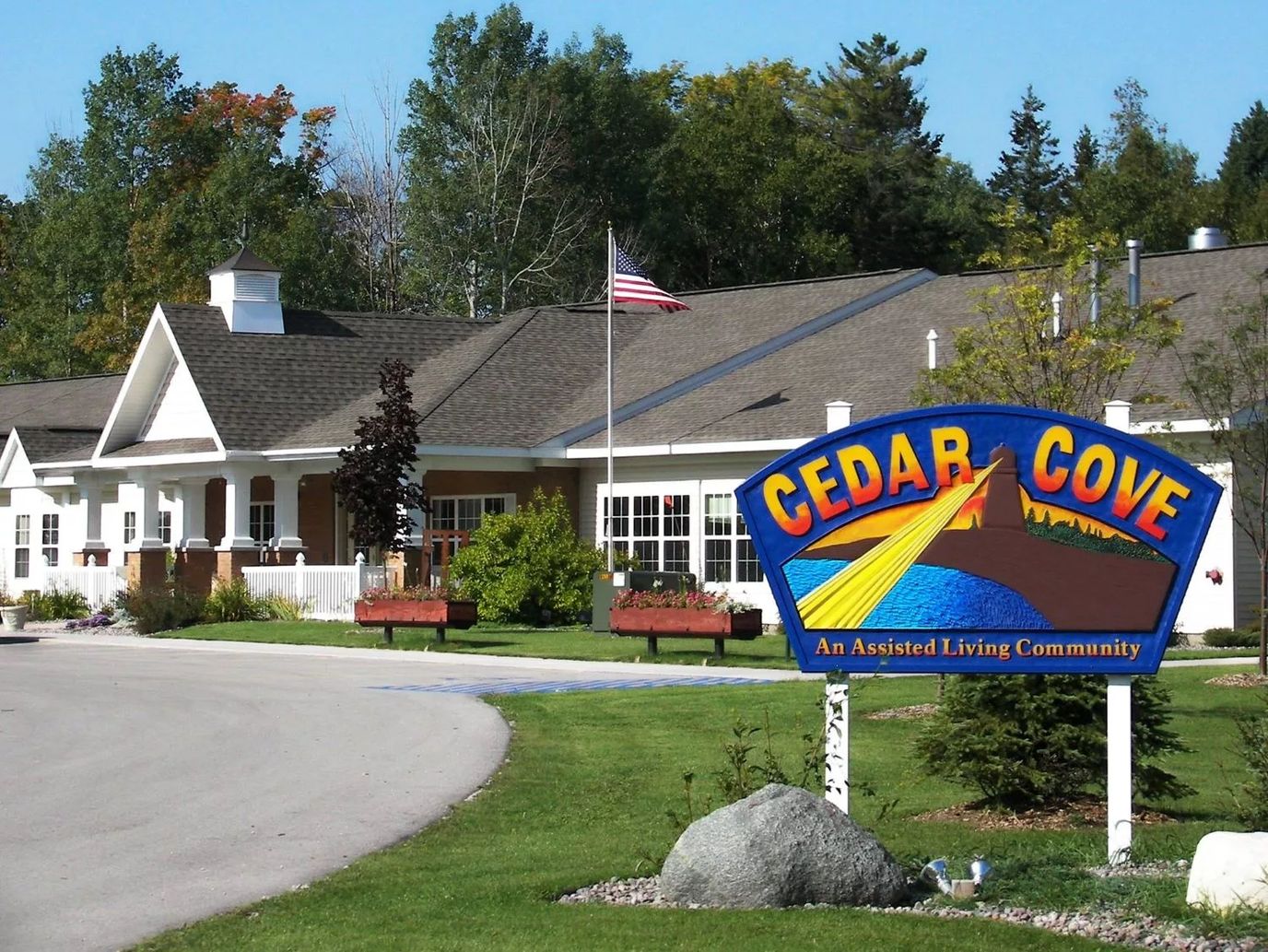 Exterior view of Cedar Cove Assisted Living with signage