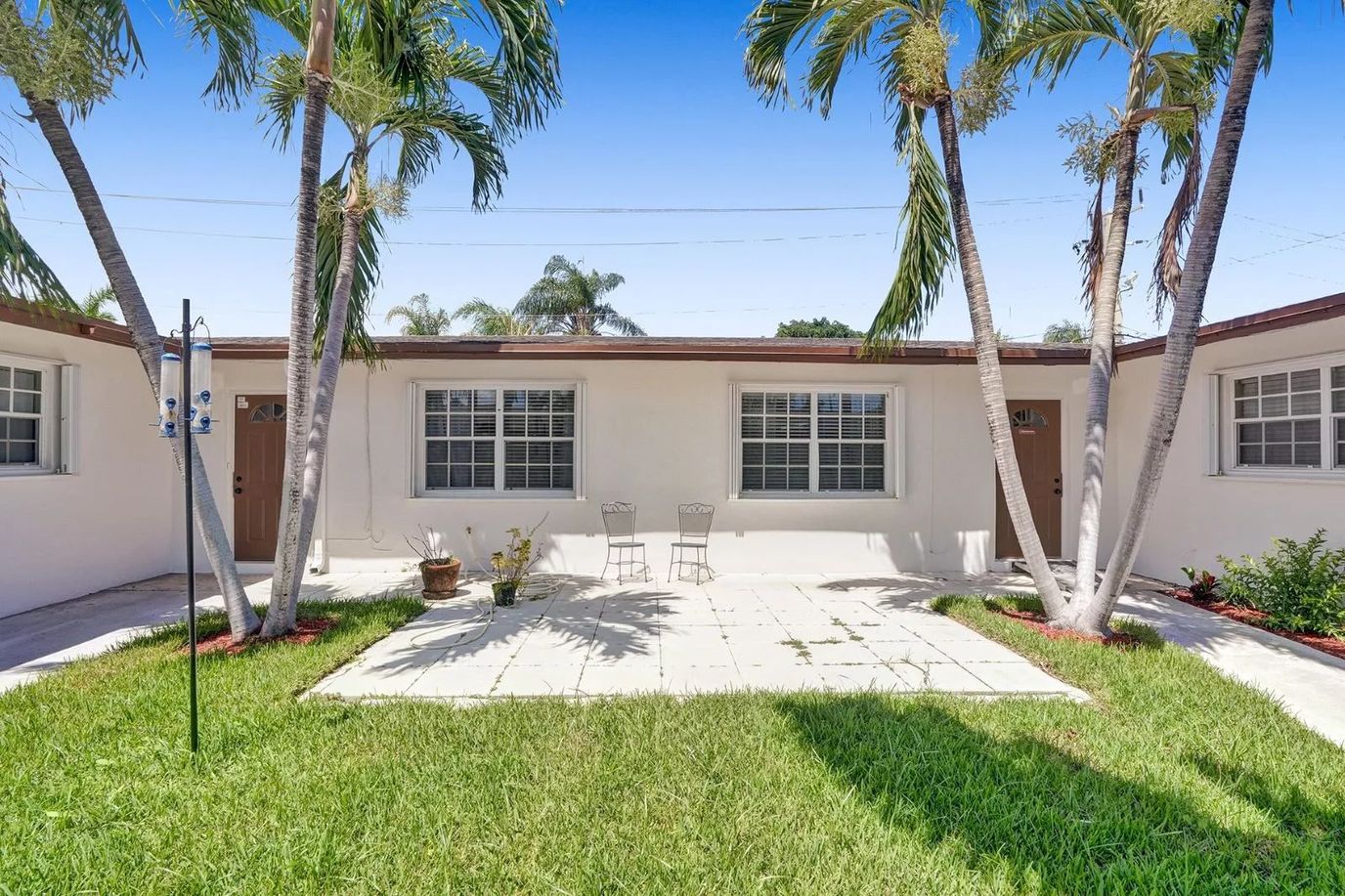 Outdoor space with seating and palm trees