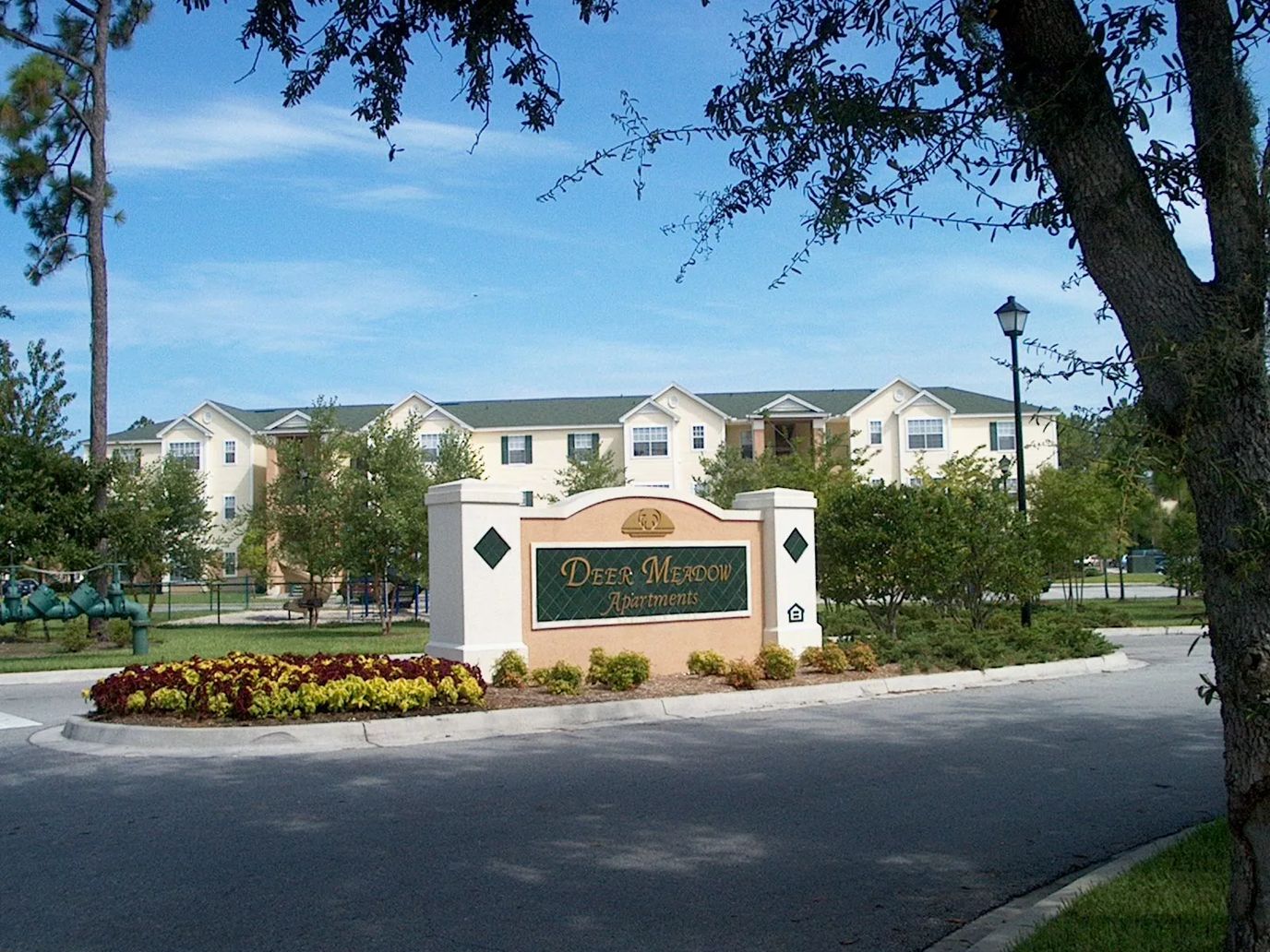Exterior view of Deer Meadows Apartments with landscaping