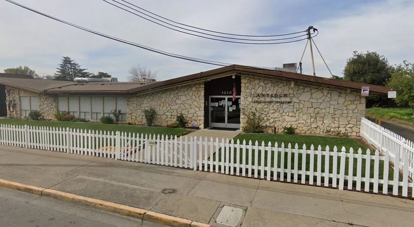 Exterior view of a senior living facility with stone facade