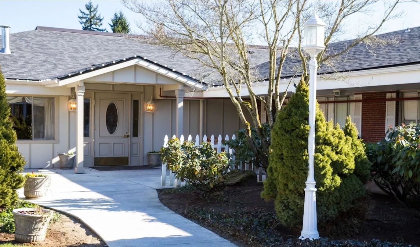 Entrance of a nursing home facility with landscaped pathway