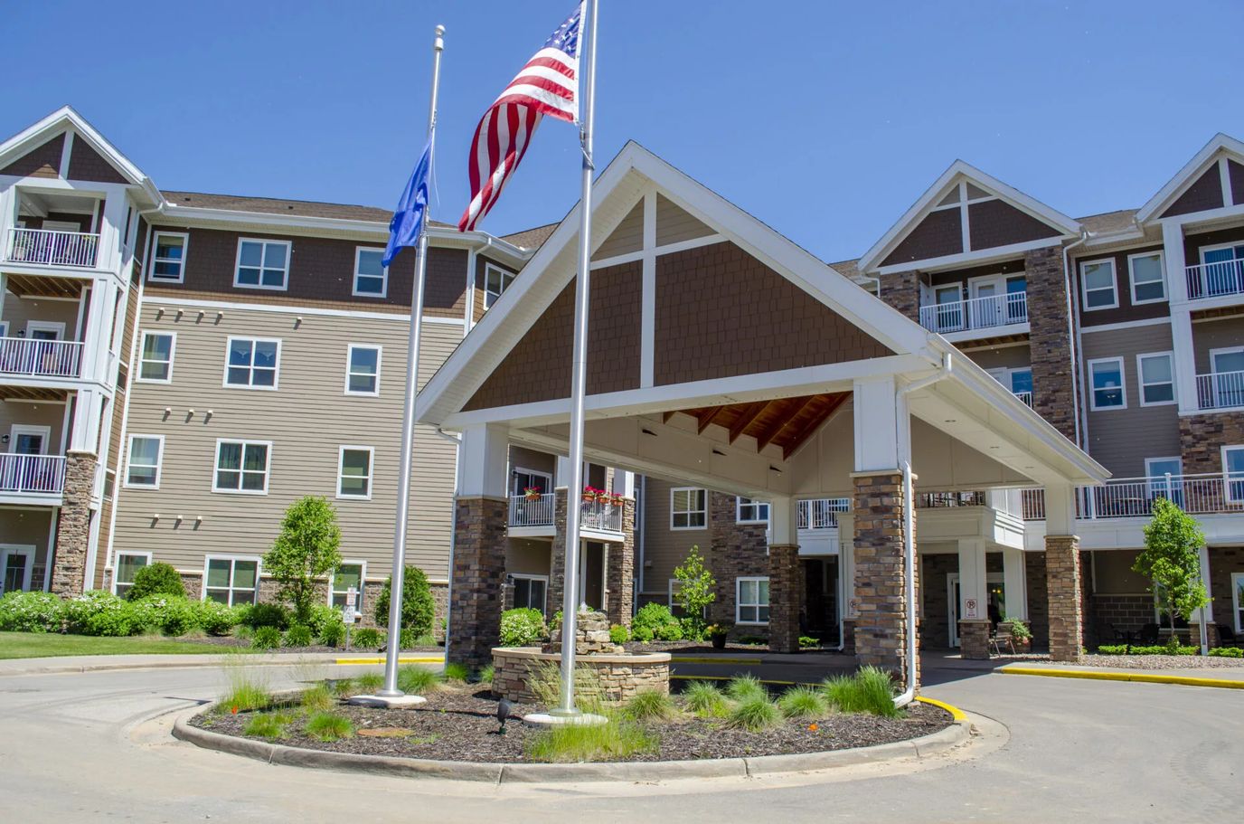 Exterior view of the Eagle Crest Assisted Living facility with flags