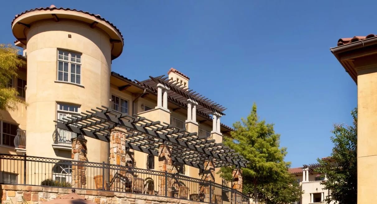Exterior view of a senior living facility with outdoor arch.