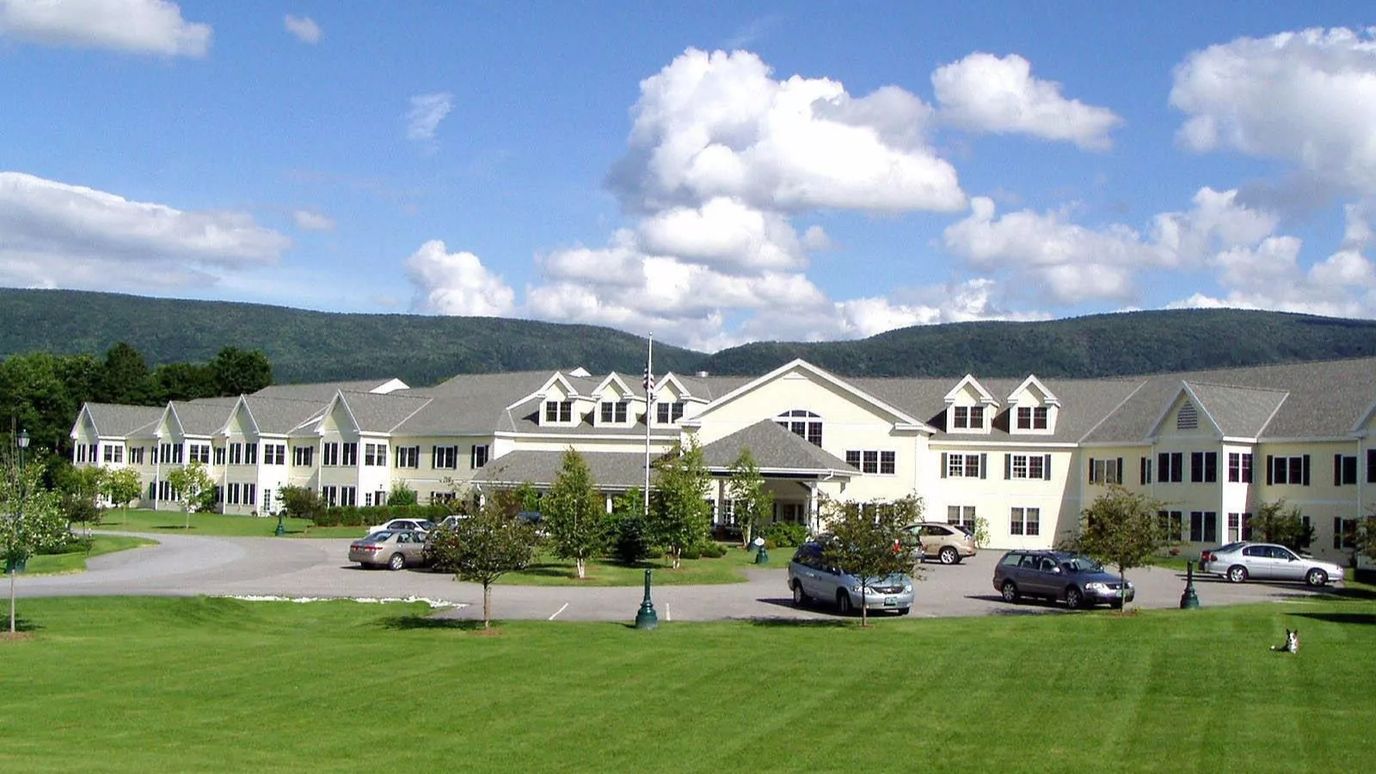 Exterior view of Equinox Village with surrounding gardens