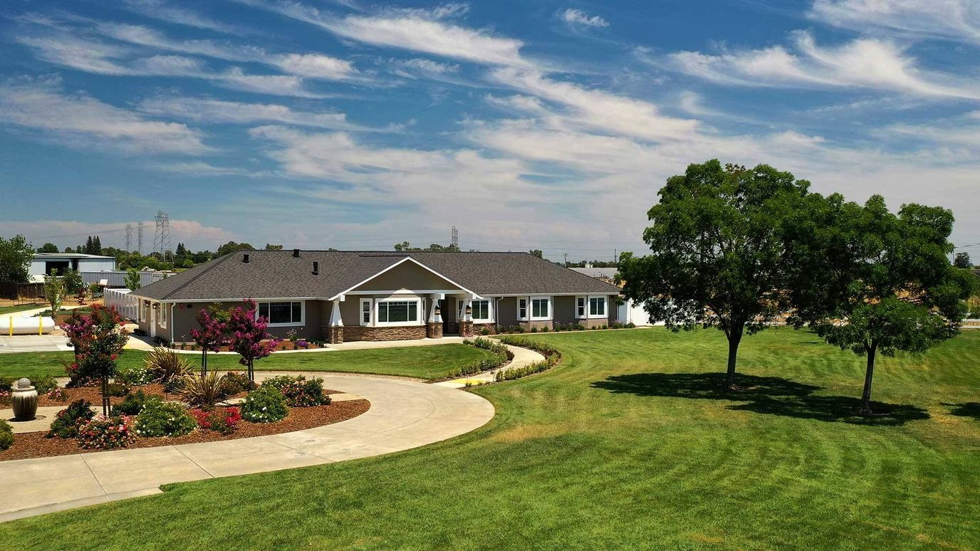 Aerial view of a senior living facility with landscaped grounds