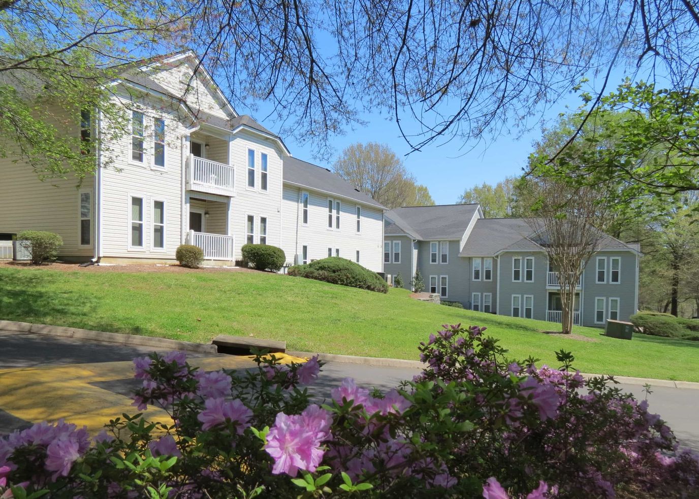 Exterior view of Fourth Creek Landing Apartments with flowers