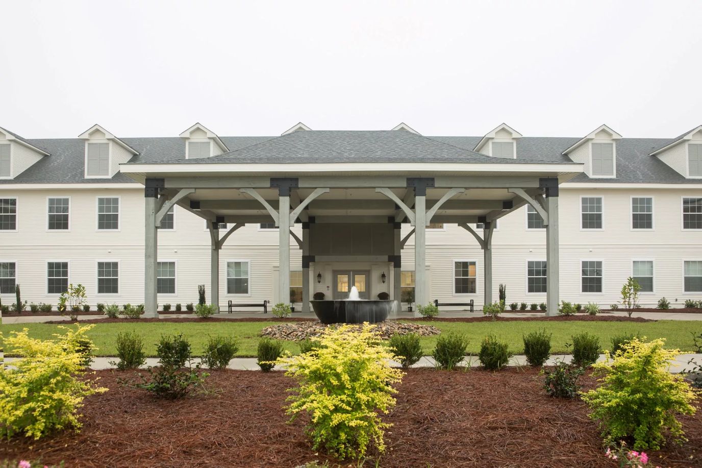 Exterior view of a senior living facility with landscaping