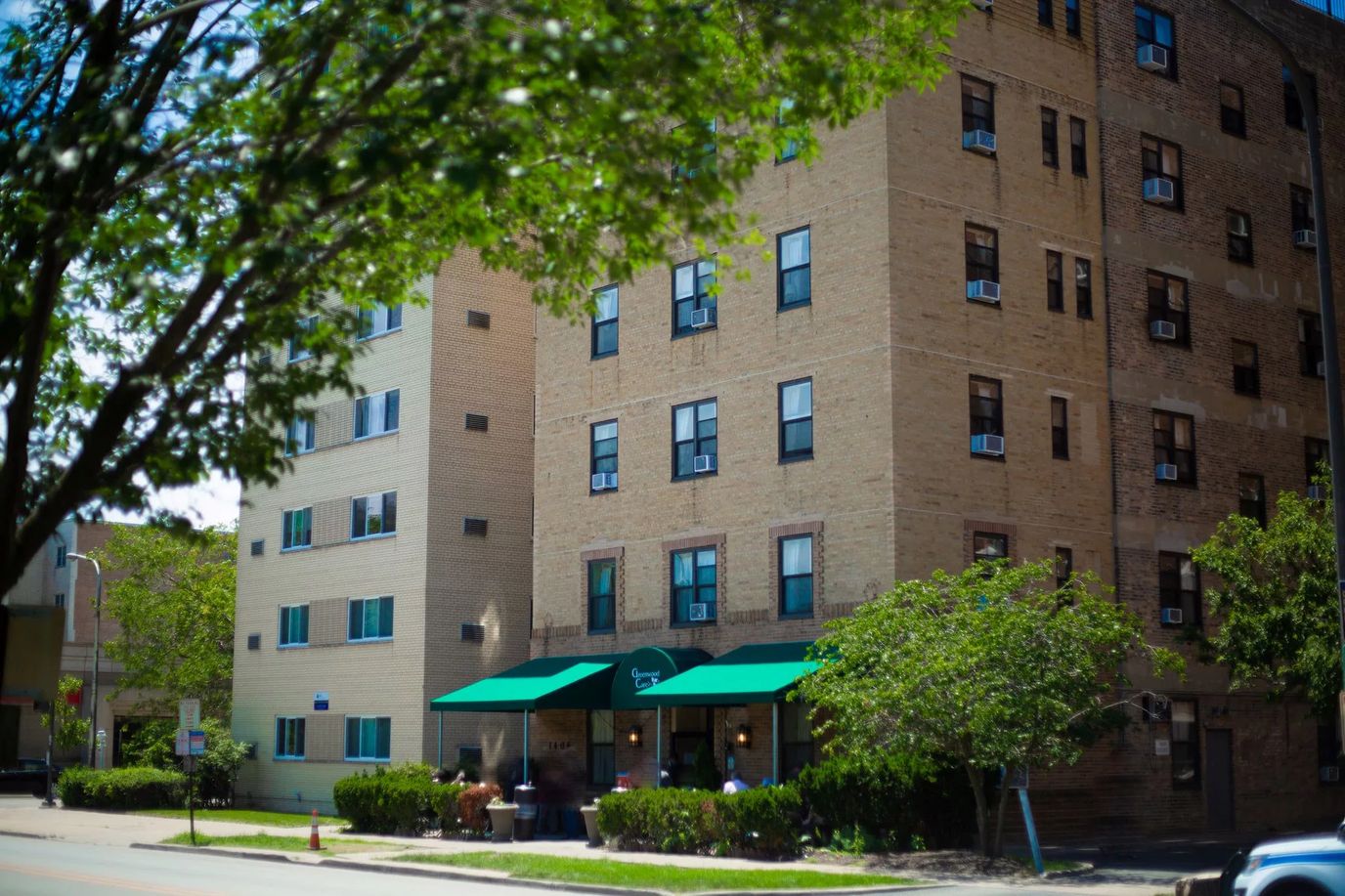 Exterior view of Greenwood Care facility with outdoor seating