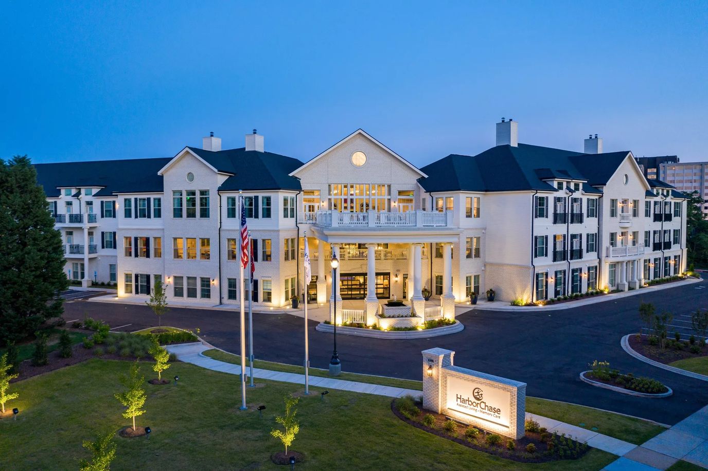 Exterior view of HarborChase with evening lighting