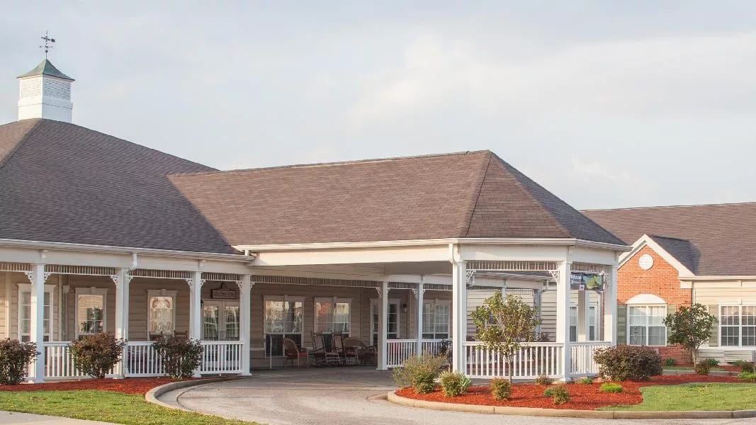 Facade of a senior living facility with outdoor seating
