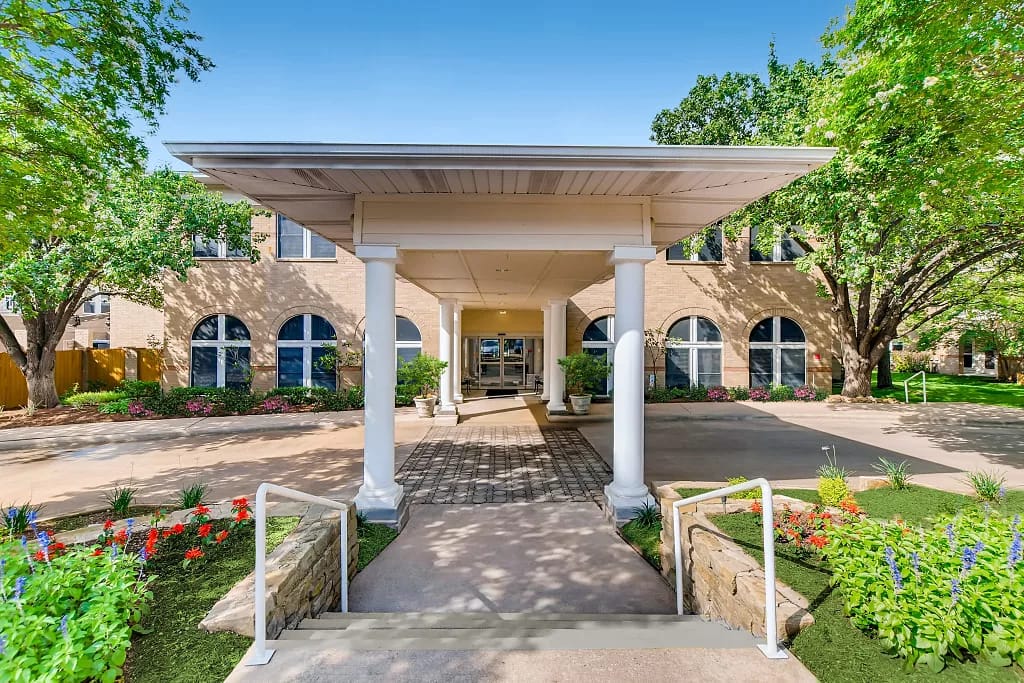 Entrance of Asher Point Senior Living with landscaped gardens