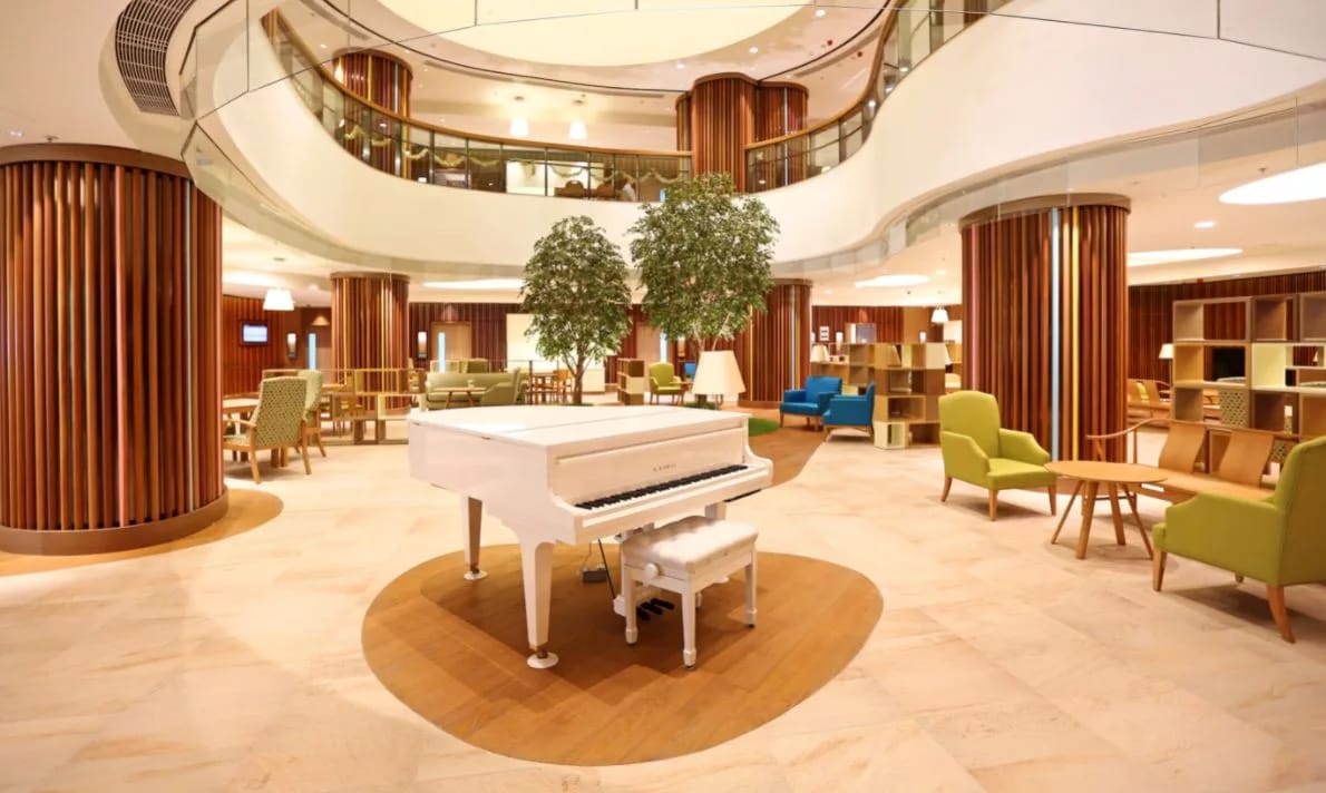 Bright common area with piano and seating