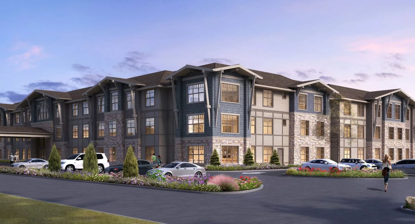 Exterior view of a senior living facility with landscaping
