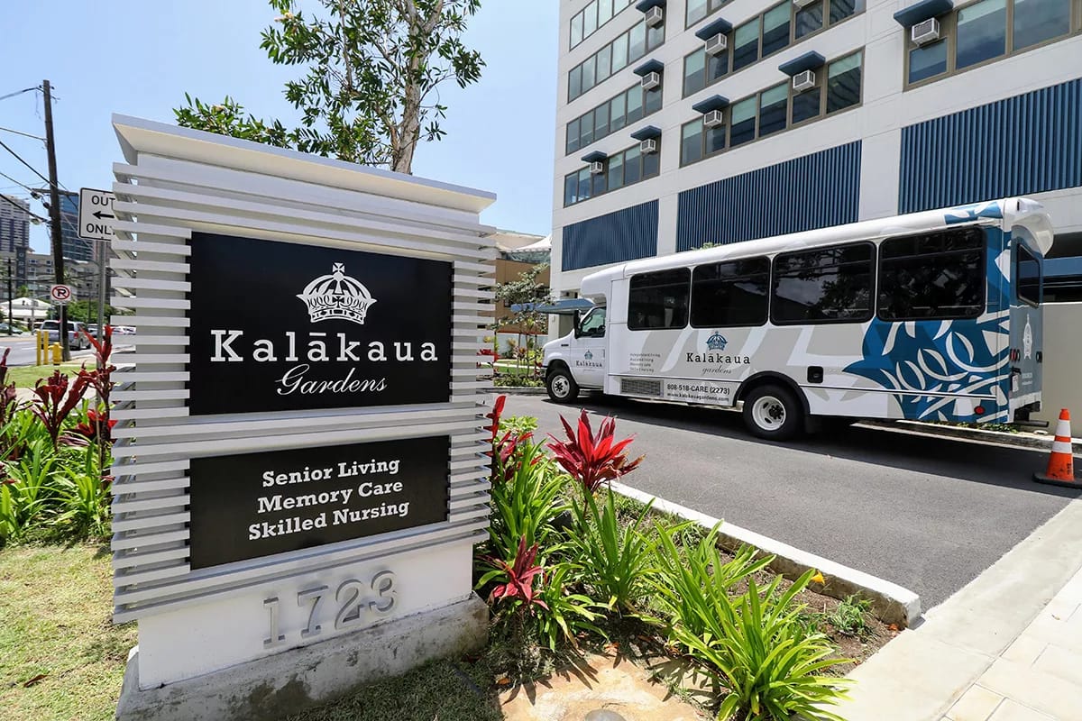 Facility sign with logo and shuttle bus in view