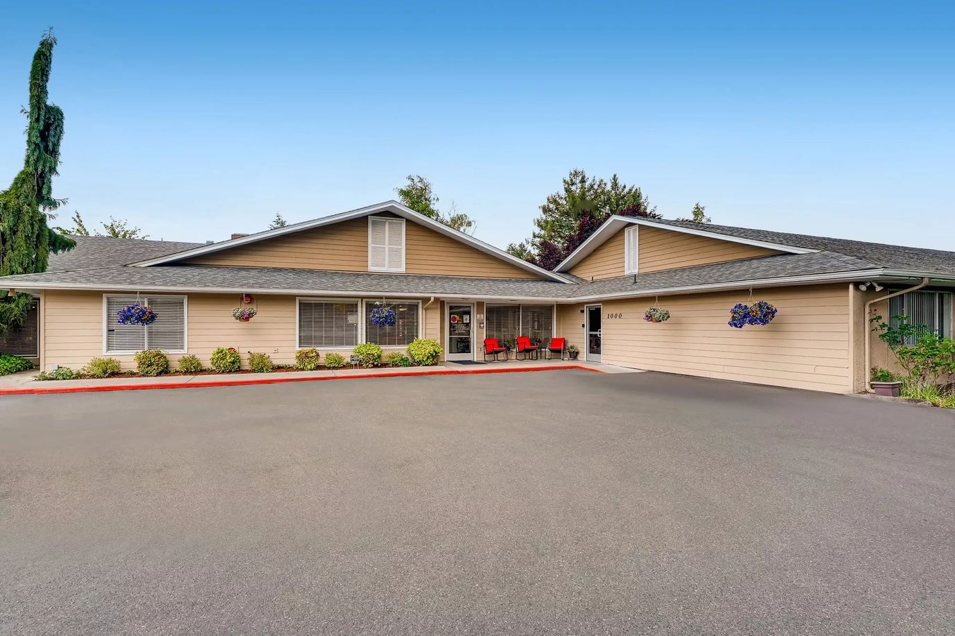 Exterior view of Kamlu Retirement Inn with seating area