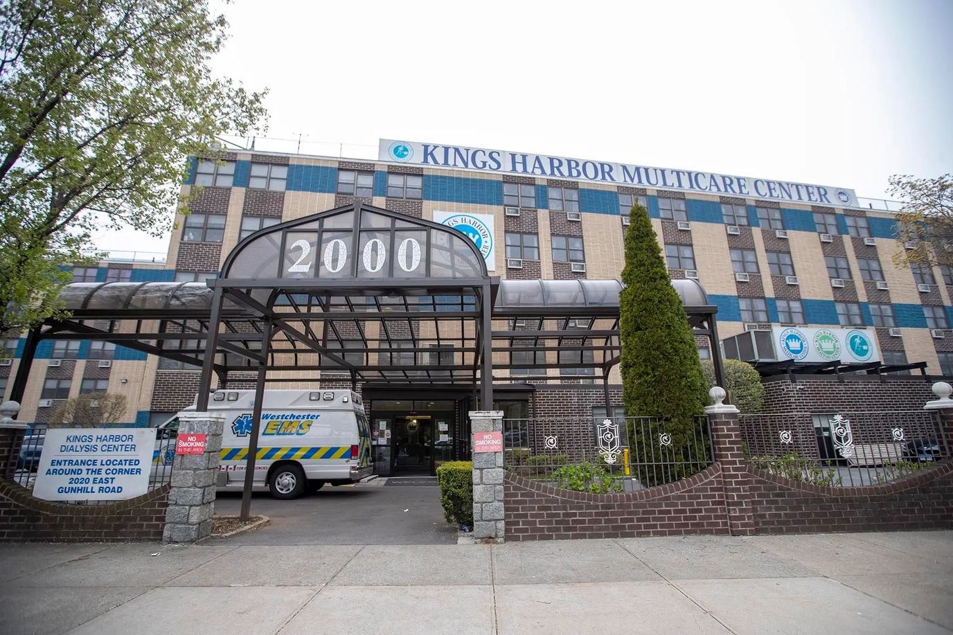Front entrance of Kings Harbor Multicare Center with parking area