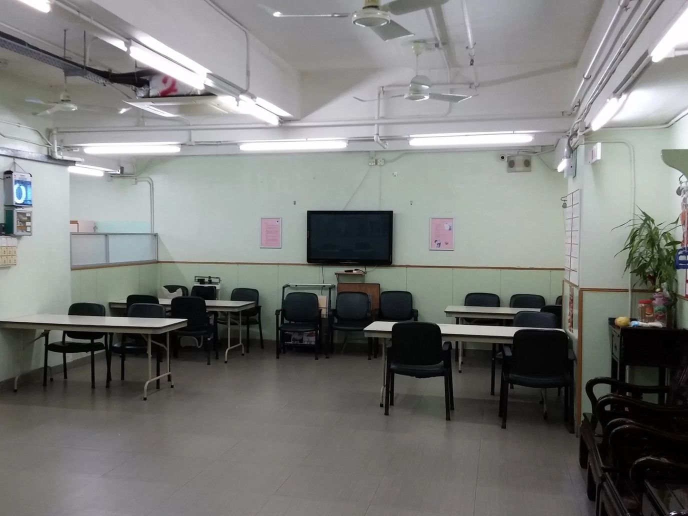 A communal activity room with tables and chairs
