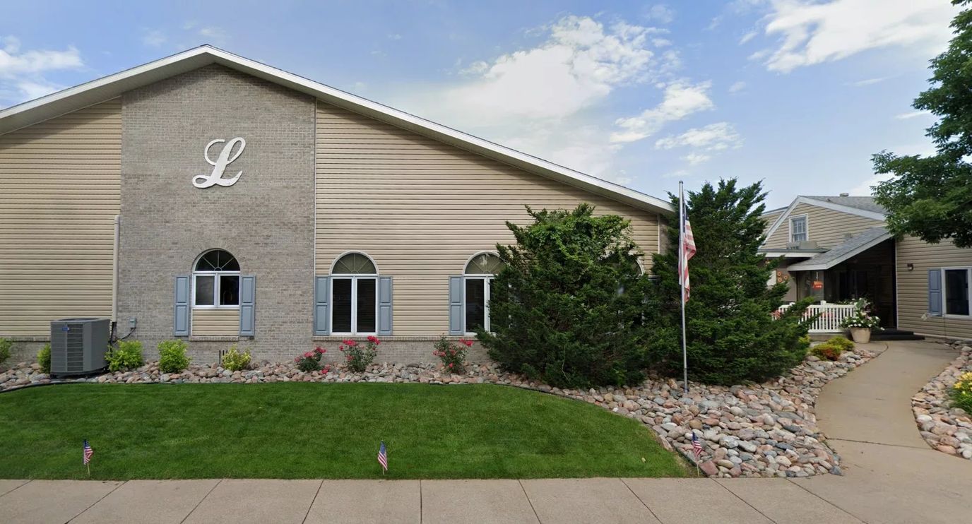 Exterior view of the assisted living facility with landscaping