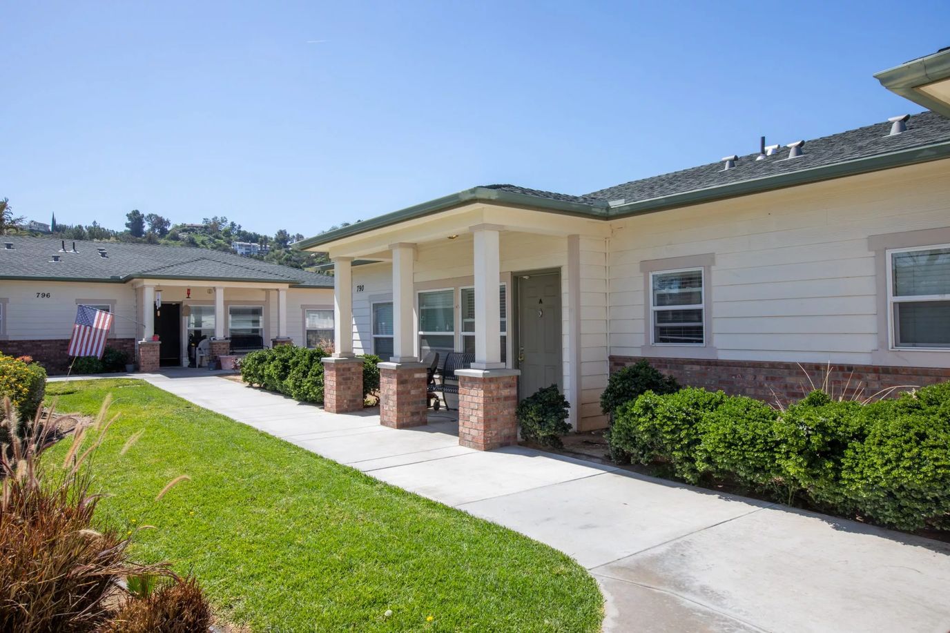 Pathway leading to senior living cottages with greenery