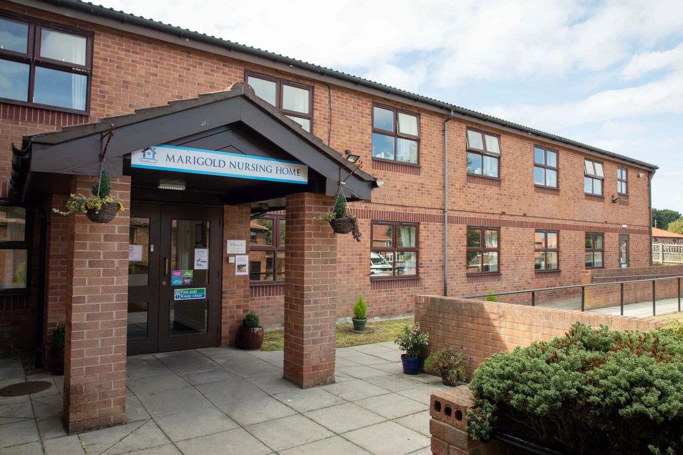 Entrance of Marigold Nursing Home with brick exterior