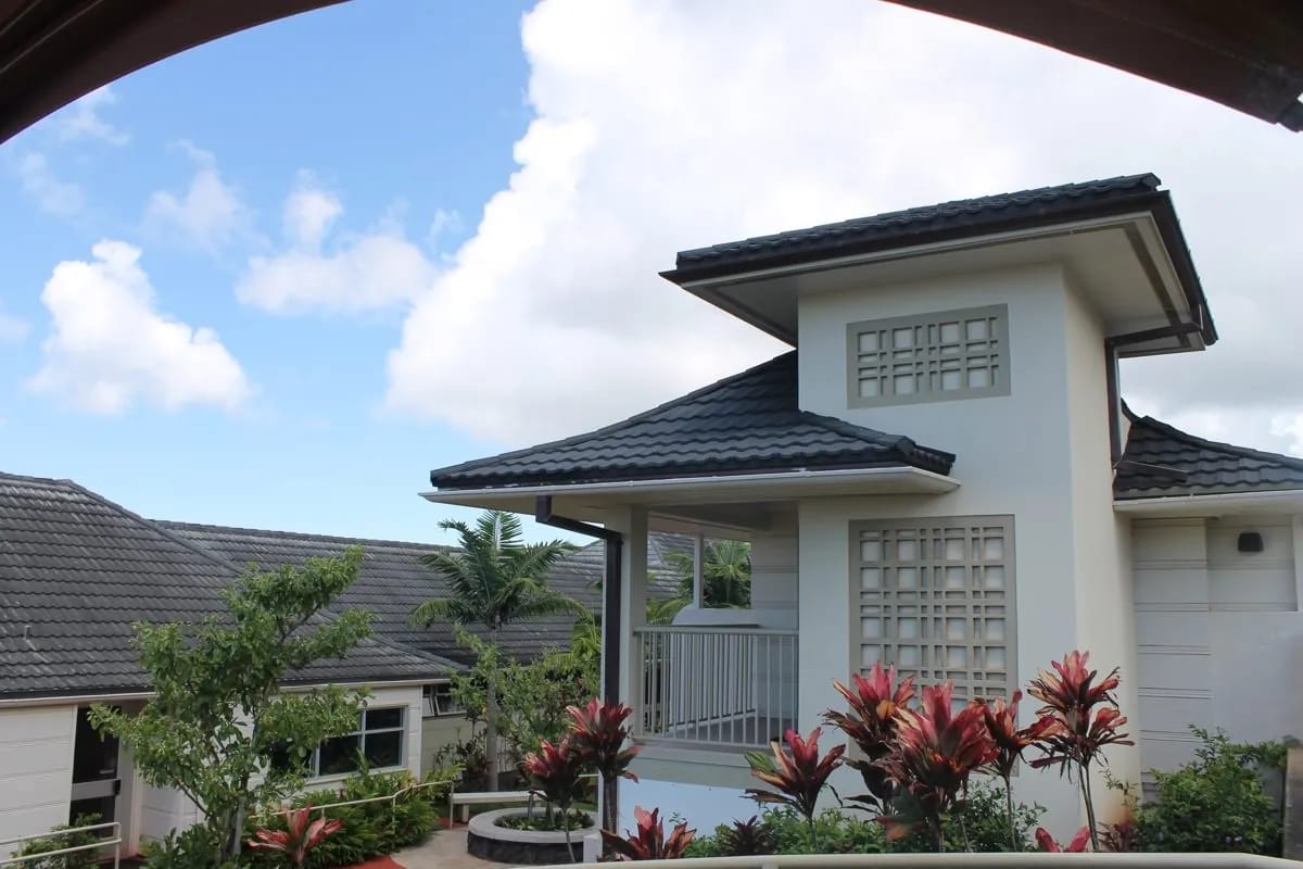 Exterior view of a nursing facility surrounded by lush greenery