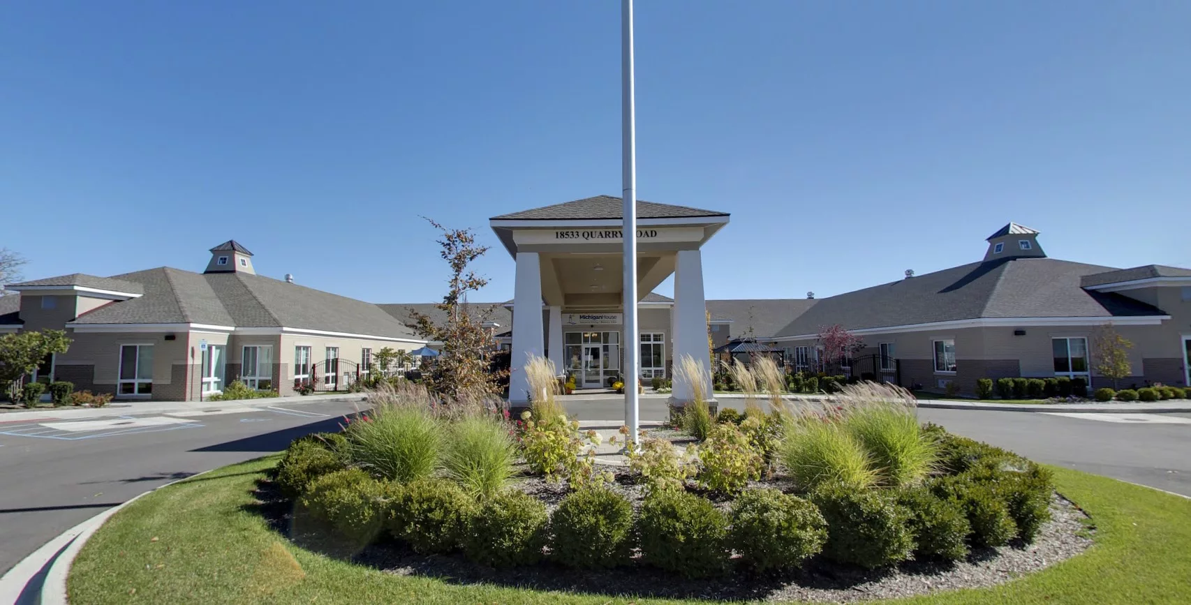 Front entrance of Michigan House Senior Living with landscaping