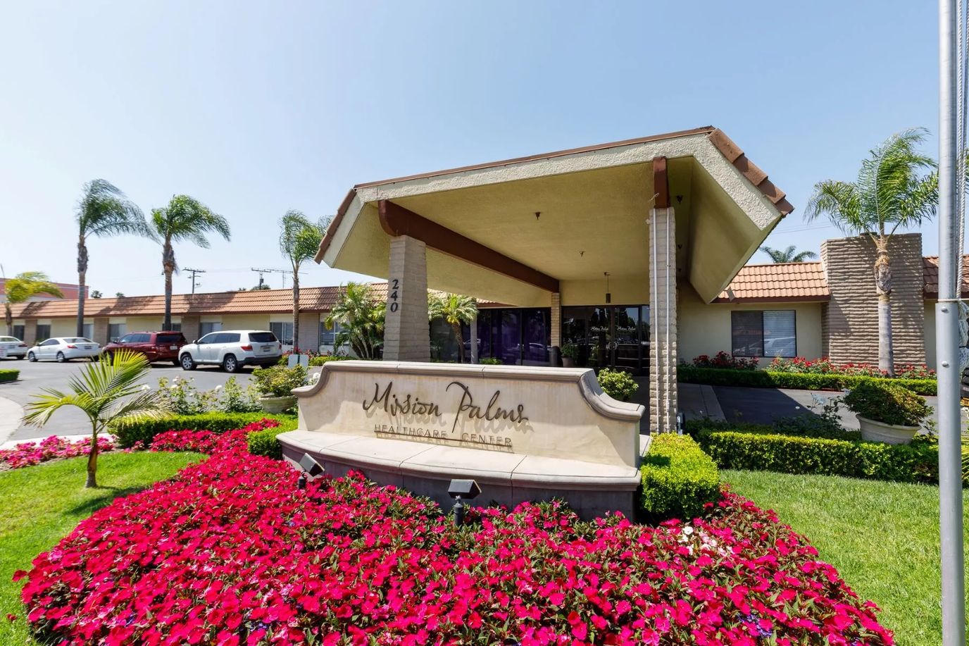 Exterior view of Mission Palms Healthcare Center with landscaped surroundings