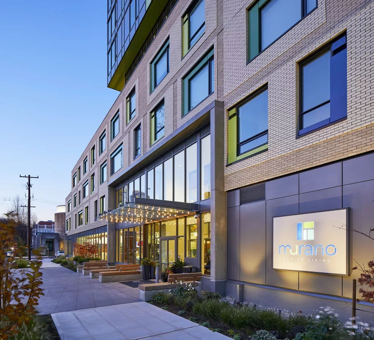 Exterior view of Murano Senior Living with entrance and landscaping