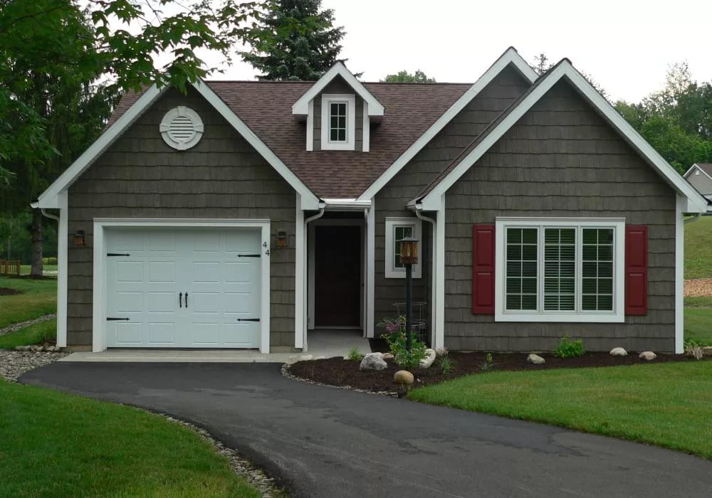 Exterior view of a cottage with a driveway.