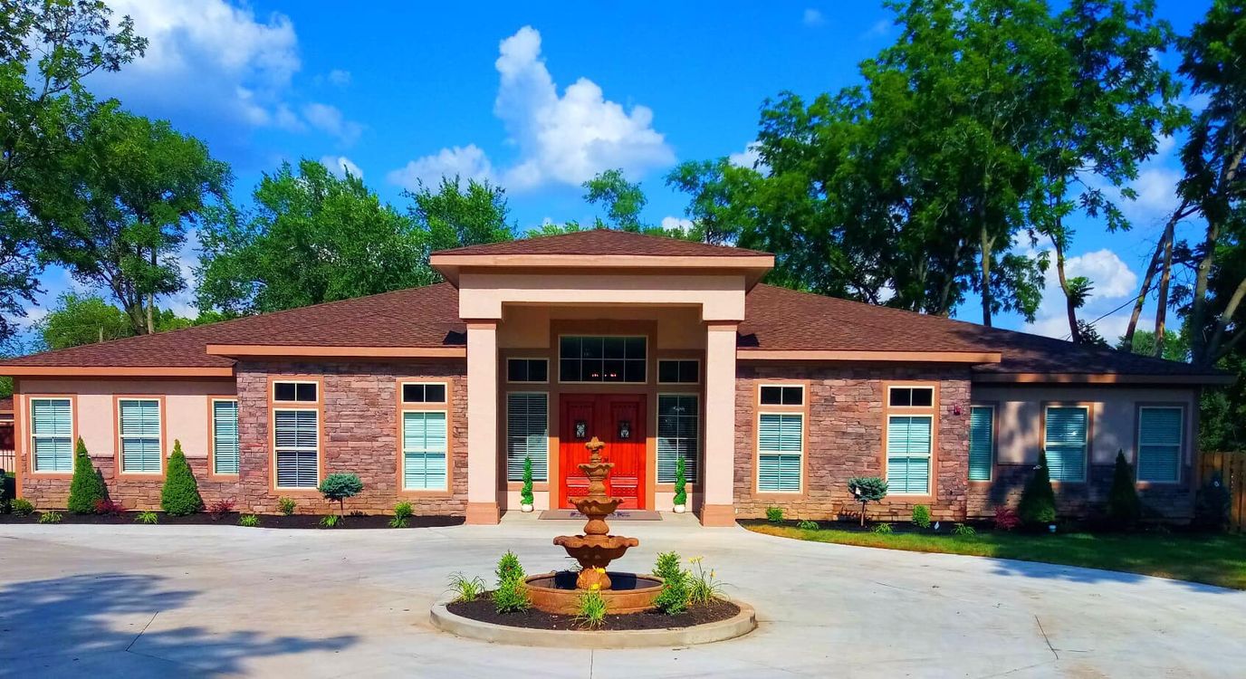 Exterior view of a senior care facility with fountain