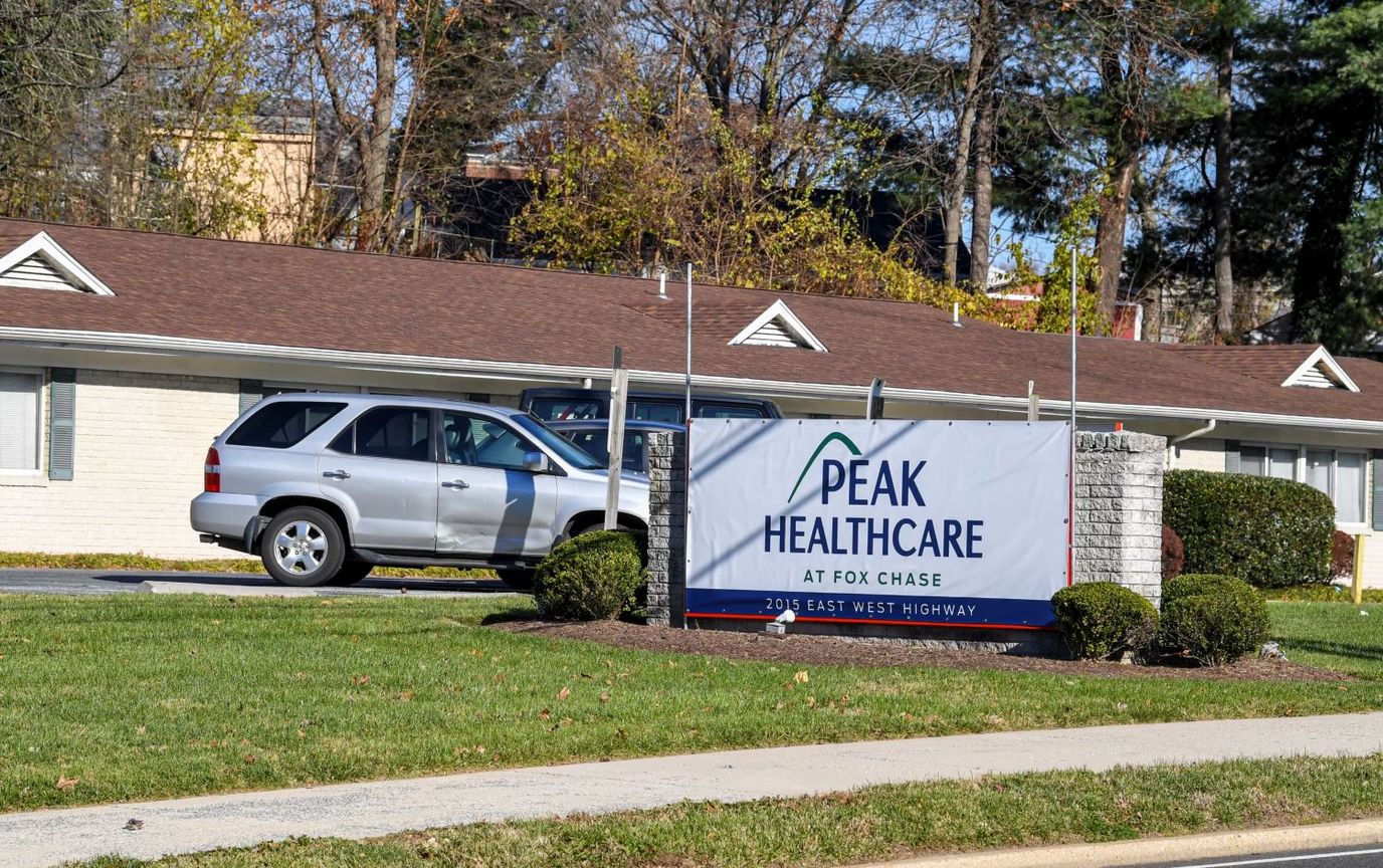 Exterior view of Peak Healthcare facility entrance with signage