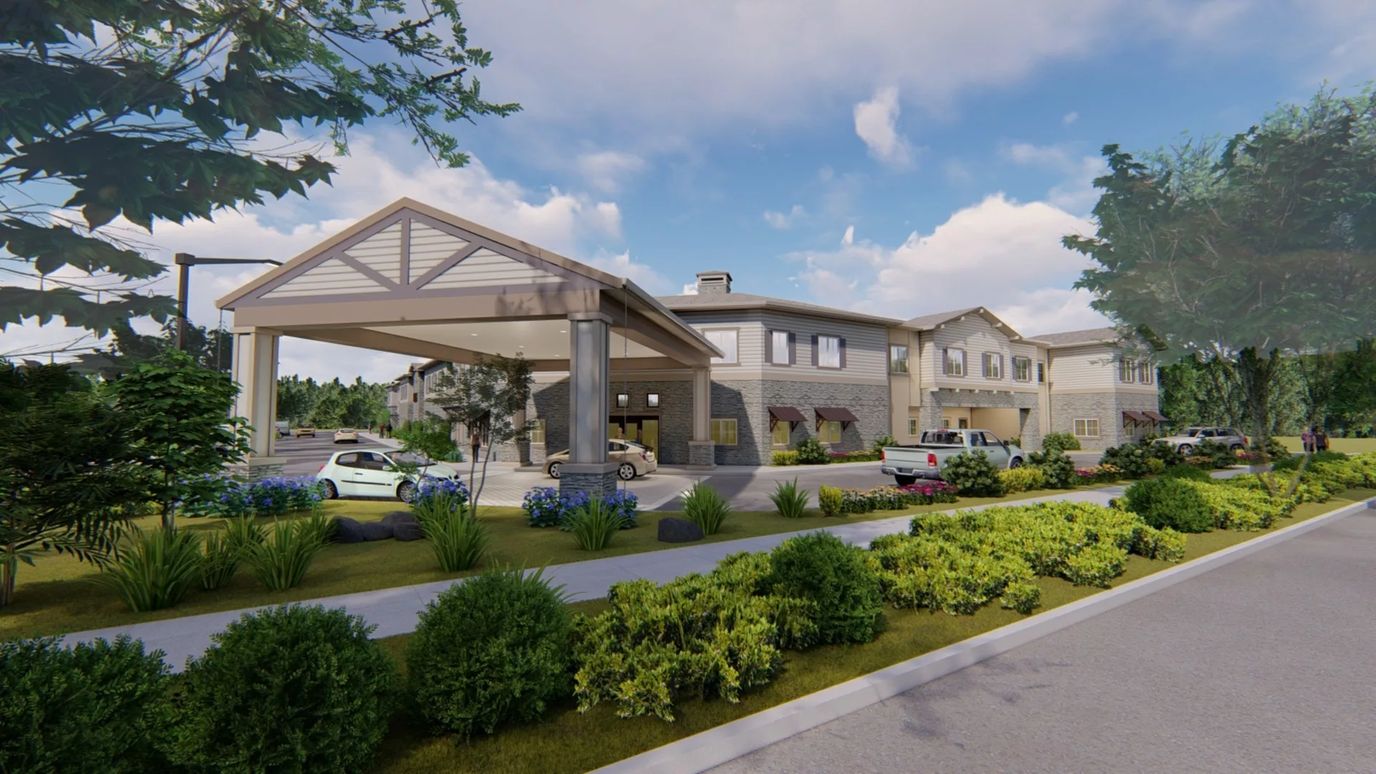 Exterior view of assisted living facility with landscaped entrance