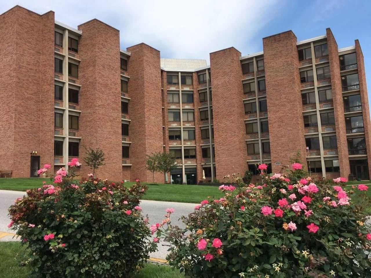 Exterior view of Pleasant Acres Nursing Center with flowers