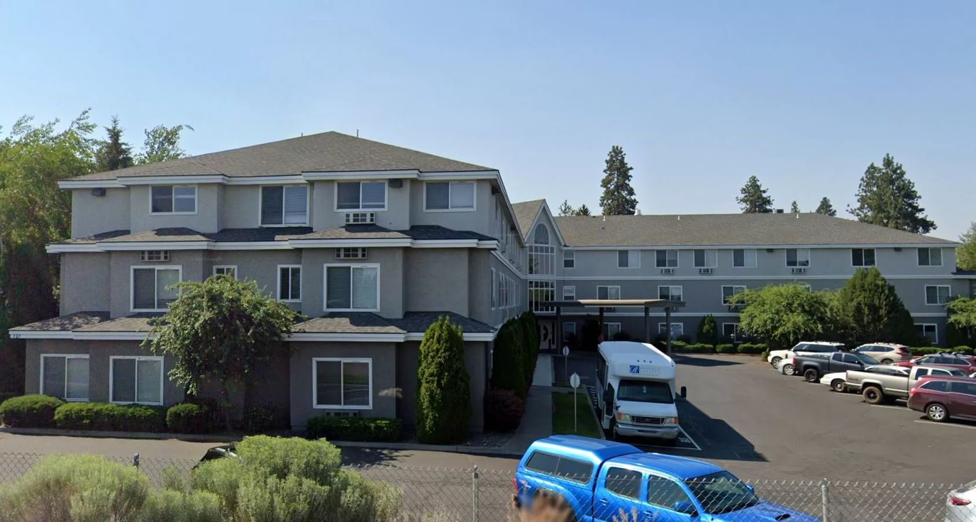 Exterior view of Regency Village at Bend with parked vehicles