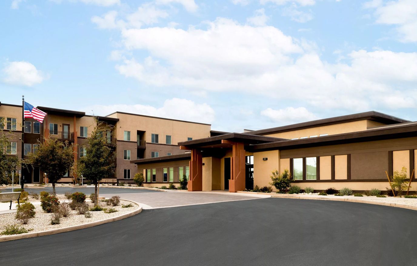 Entrance of a senior living facility with outdoor landscaping