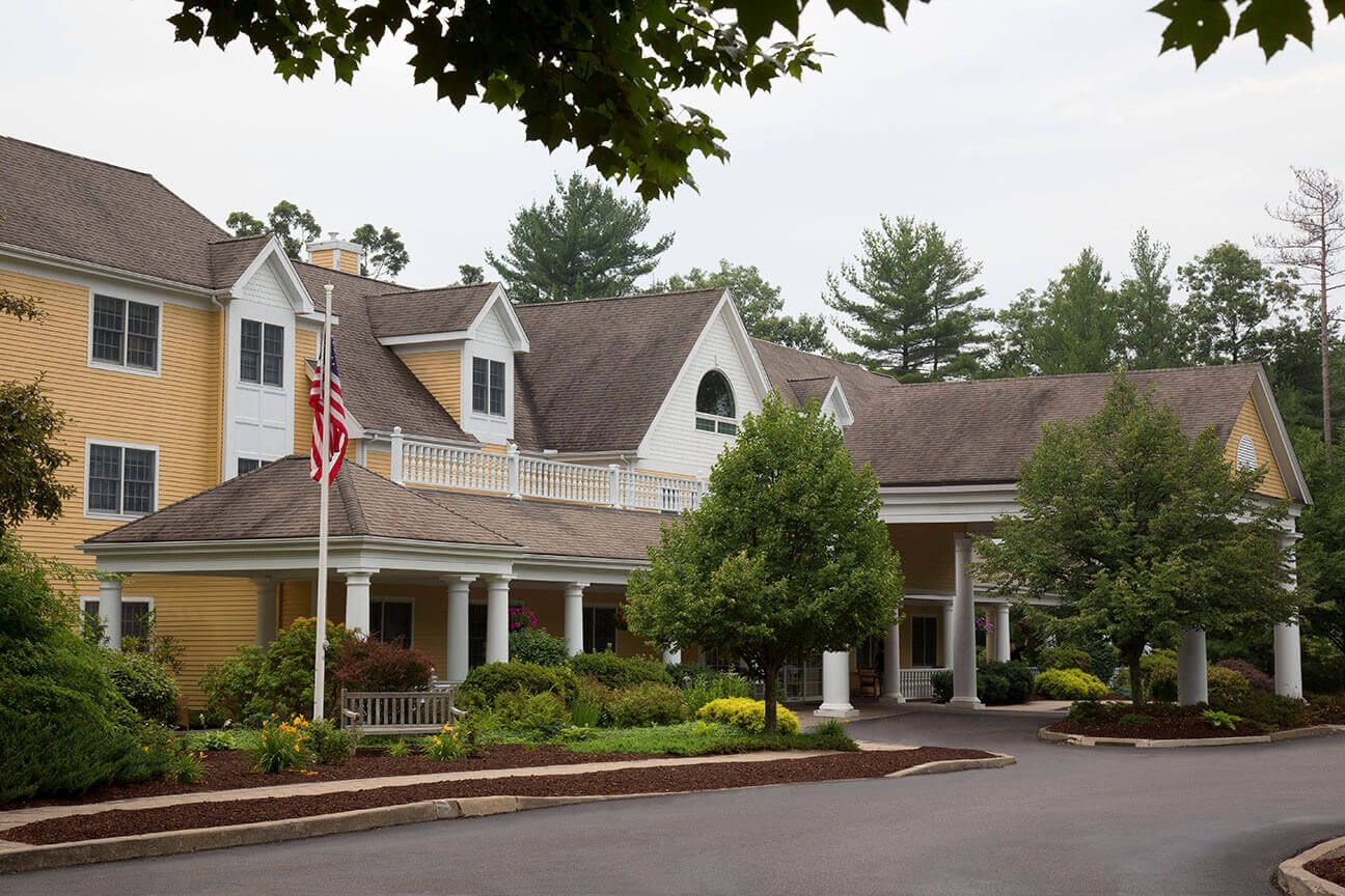 Front exterior of River Ridge at Avon with landscaped entrance