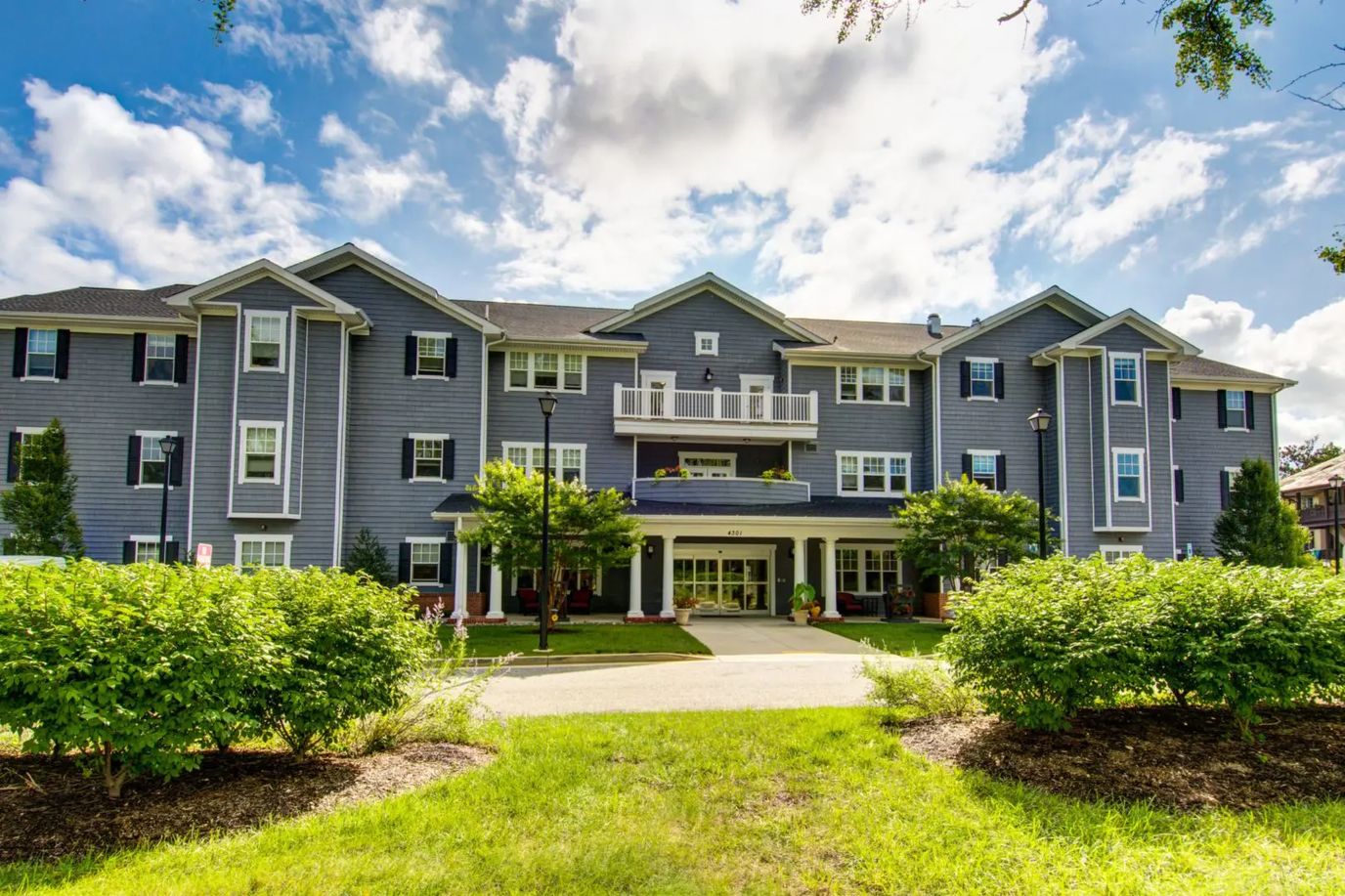 Front exterior view of Symphony Manor with landscaping