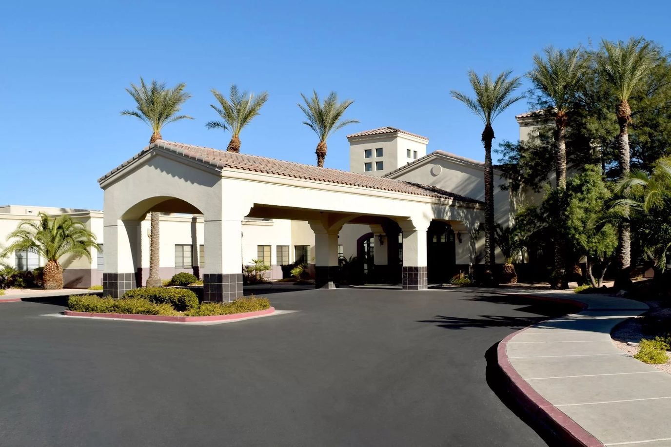 Entrance of the TLC Care Center with palm trees
