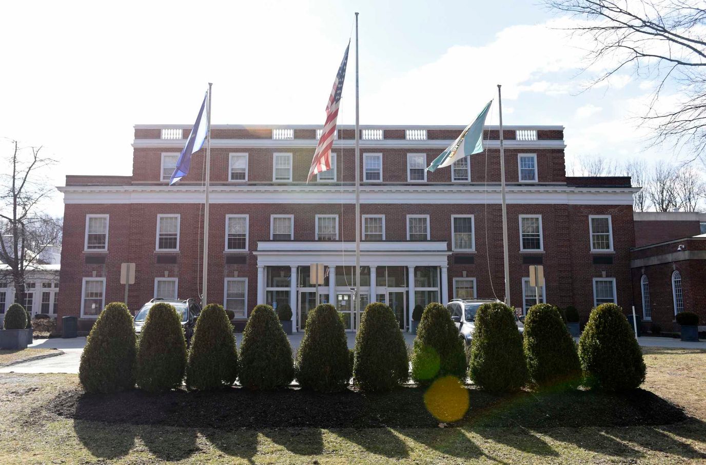 Front entrance of The Nathaniel Witherell with flags