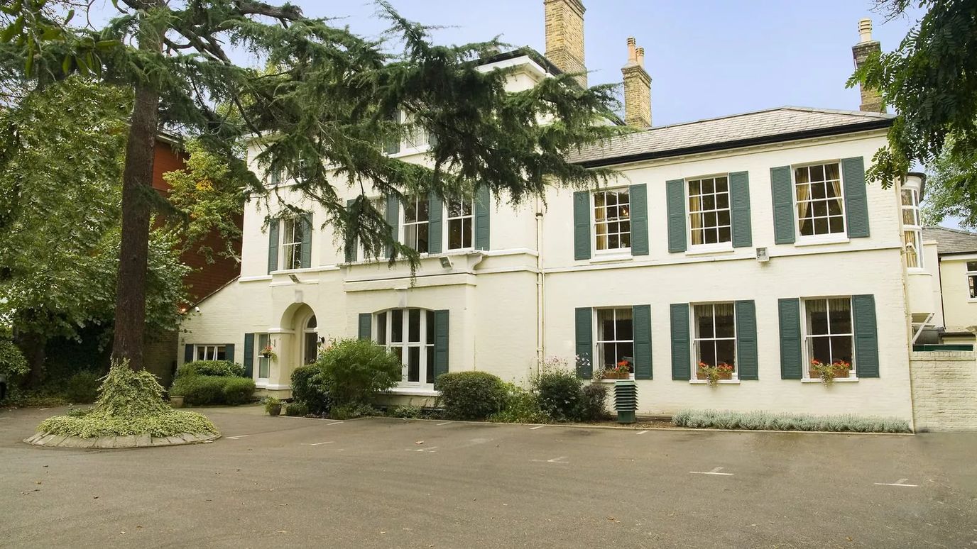 Exterior view of a nursing home building with trees