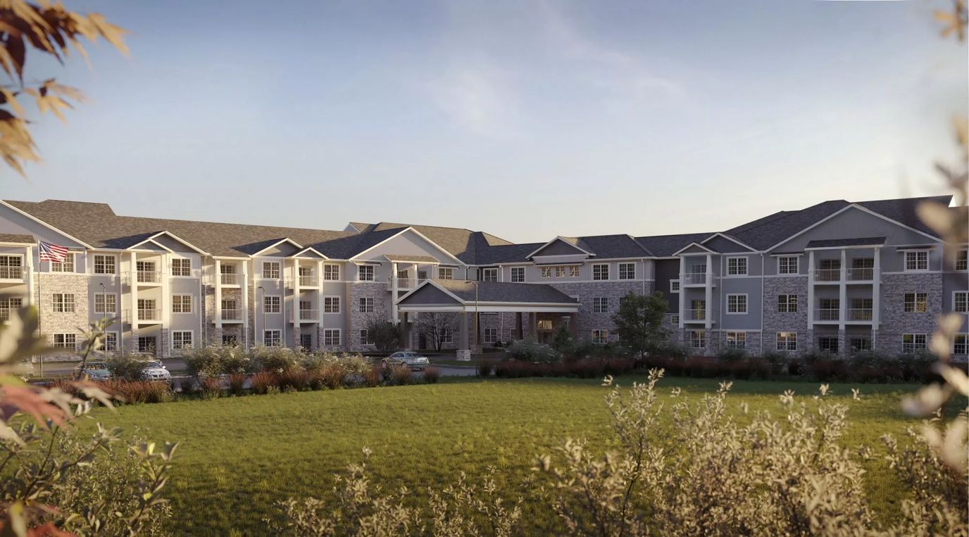 Exterior view of a senior living facility with gardens