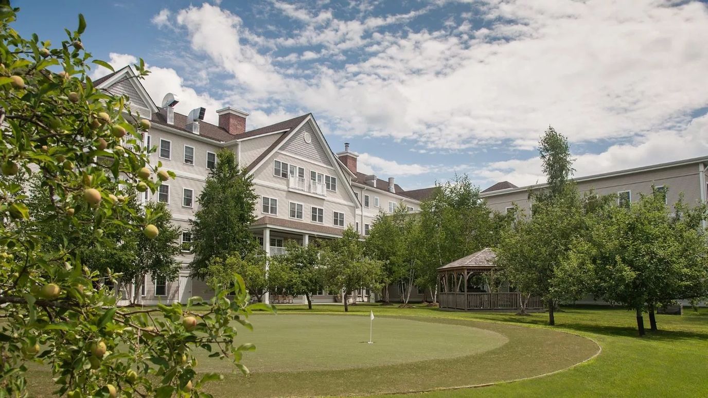 Exterior view of a senior living facility with green space