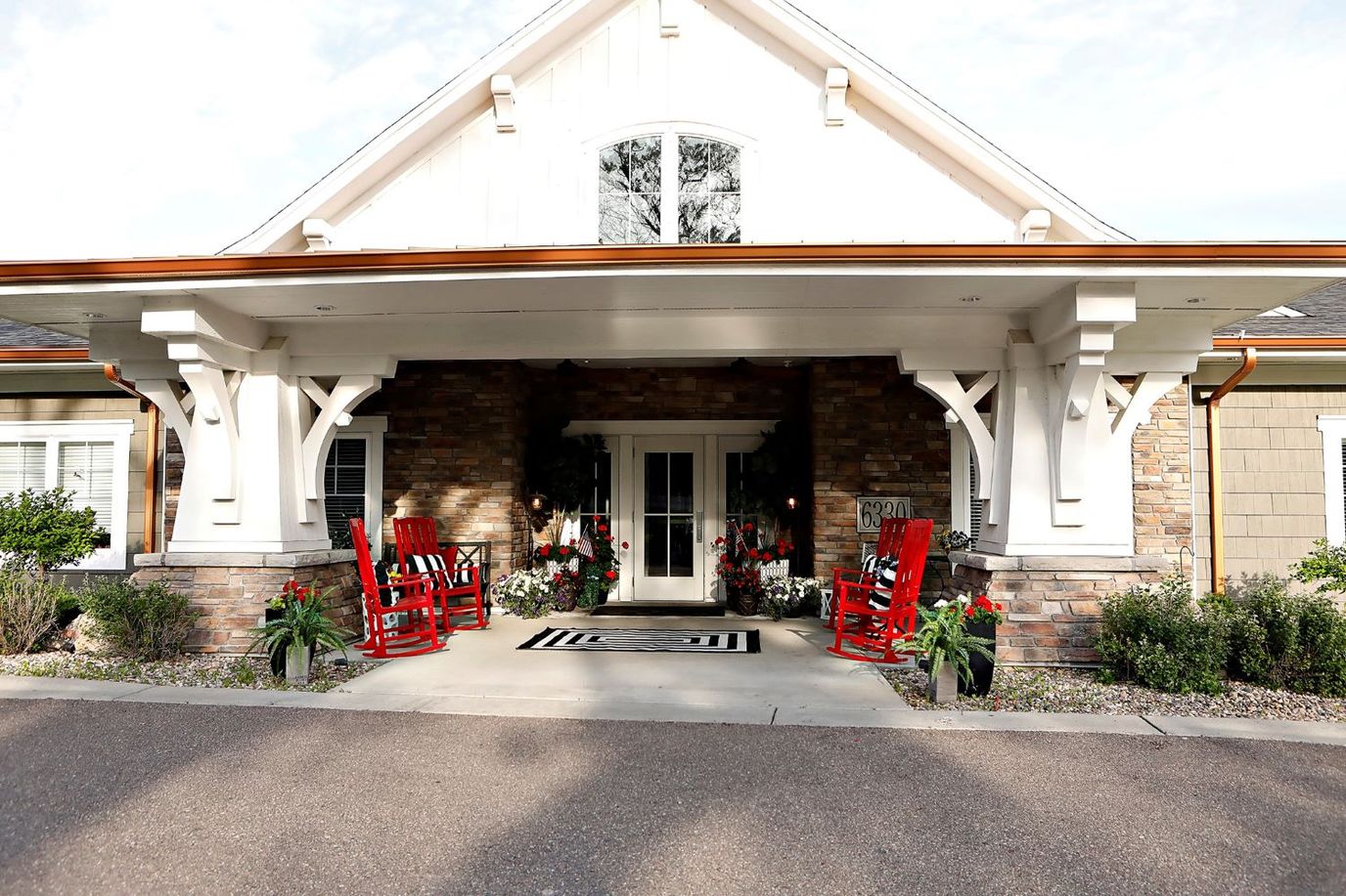 Entrance of the Trouvaille Memory Care Suites with rocking chairs